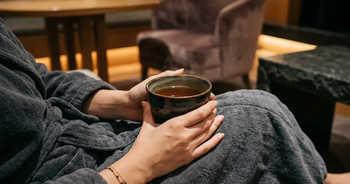 Woman relaxing with a cup of tea after her session