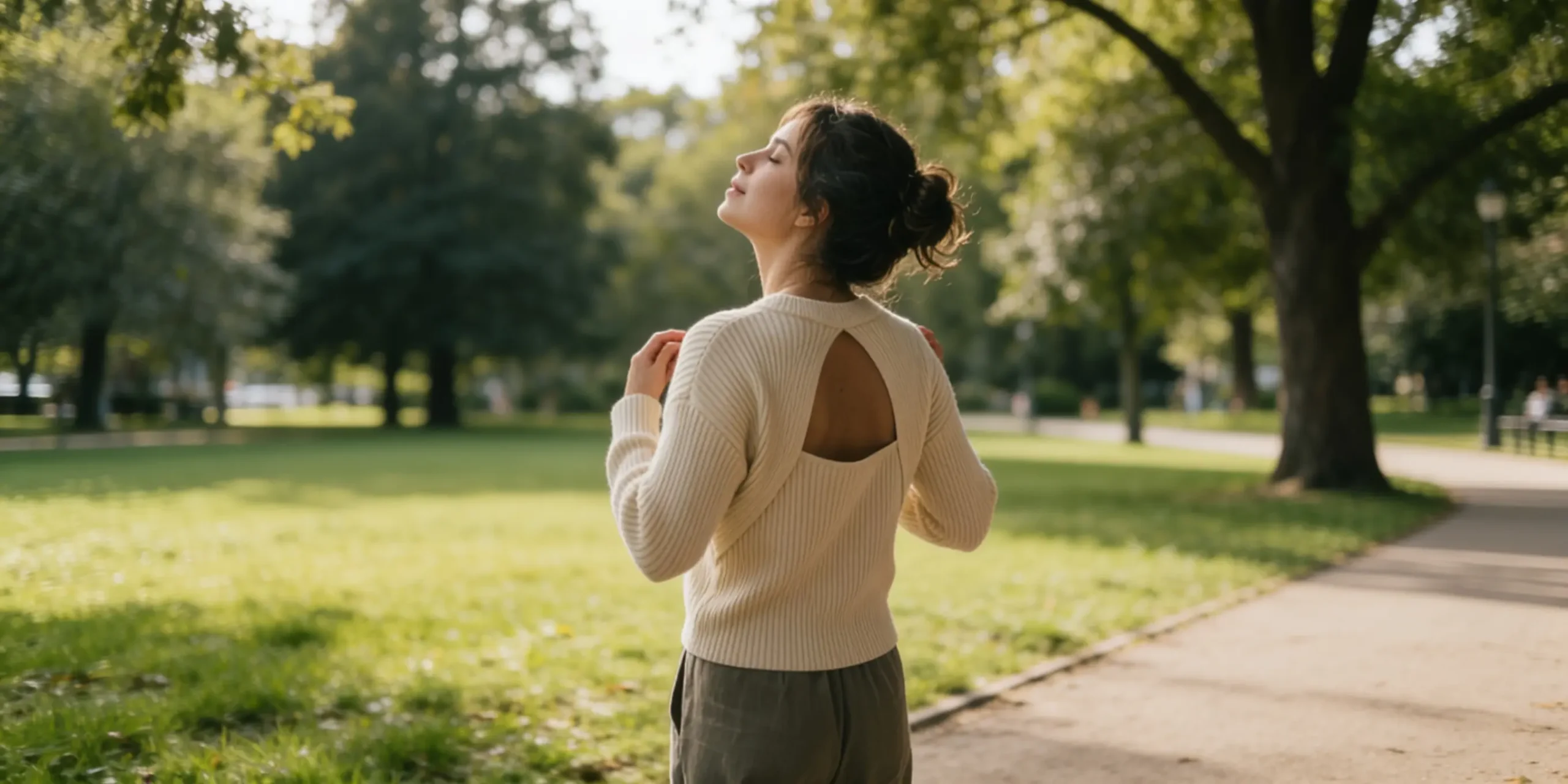 Woman taking a deep breath in a green park