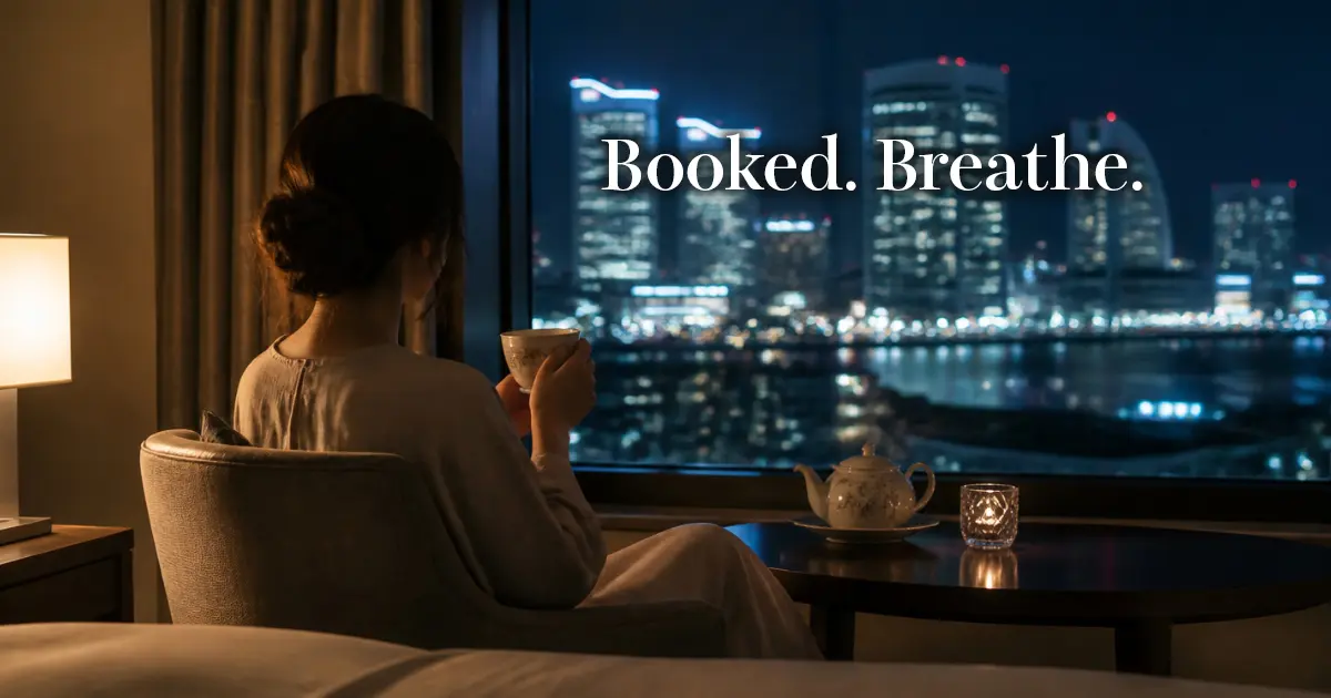 Woman relaxing with tea by a hotel window at night, seen from behind