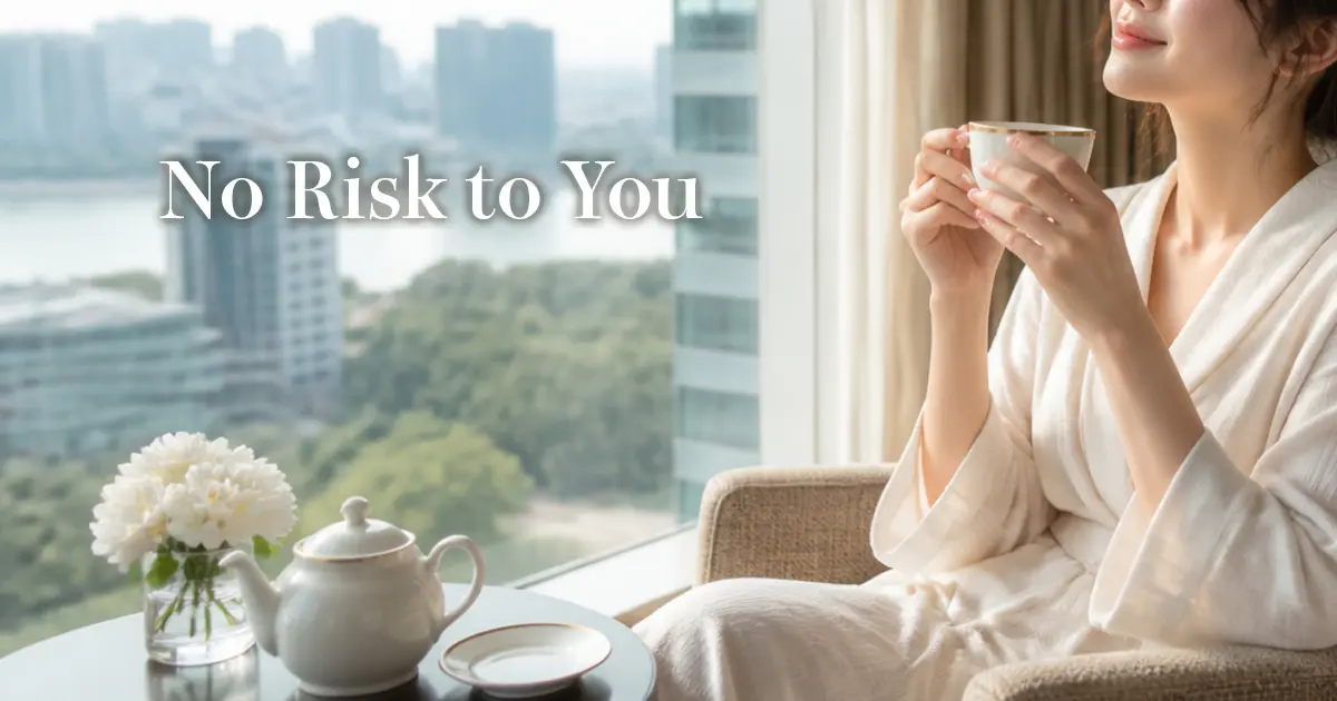 Relaxed woman having tea by a hotel window, shoulders at ease
