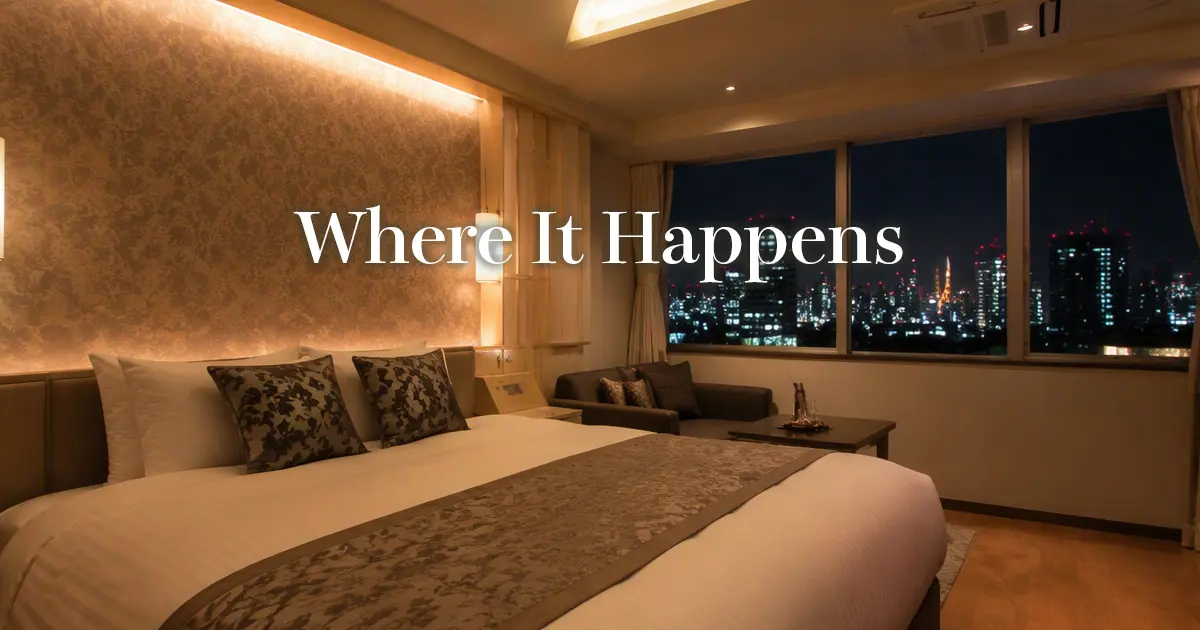 Softly lit love hotel room in Tokyo with a neatly made bed and city lights beyond the window